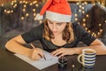 Merry christmas and a happy new year. Calligrapher Young Woman writes phrase on white paper. Inscribing ornamental Royalty Free Stock Photo