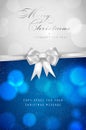 Christmas card with silver bow and shiny blurred bokeh circles