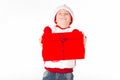 Merry christmas. Happy New Year. Caucasian young schoolboy in Santa costume holds a red Christmas box