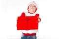 Merry christmas. Happy New Year. Caucasian young schoolboy in Santa costume holds a red Christmas box