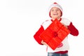 Merry christmas. Happy New Year. Caucasian young schoolboy in Santa costume holds a red Christmas box