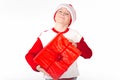 Merry christmas. Happy New Year. Caucasian young schoolboy in Santa costume holds a red Christmas box