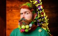 Merry Christmas and Happy New Year. Christmas atmosphere. Closeup portrait serious bearded man with Christmas decorated Royalty Free Stock Photo