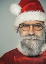 Merry Christmas and Happy New Year. Closeup portrait Santa Claus in glasses with frozen beard. Winter holidays