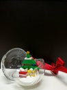 Merry Christmas and Happy New Year, colorful Xmas tree and tiny gift box toy decoration in the clear ball Royalty Free Stock Photo