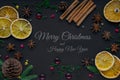 Merry Christmas and happy new year. composition on a black background of Christmas tree branches, cones, toys, cinnamon, dried Royalty Free Stock Photo
