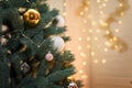 Merry Christmas and happy new year concept, Closeup of white and golden baubles hanging from a decorated tree with bokeh Royalty Free Stock Photo