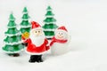 Merry Christmas and happy new year concept. Cute santa claus figure and tree on snow with copy space