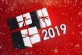 Merry Christmas and Happy new year 2019 Concept. Gift boxes on red background, top view with snowflakes Royalty Free Stock Photo