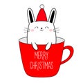 Merry Christmas Happy New Year. Cute bunnny in cup of coffee tea. Red Santa hat. Funny kawaii doodle animal. Line rabbit hare. Royalty Free Stock Photo
