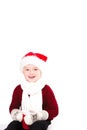 Merry Christmas and happy New year! Cute happy little boy holding red cup. Kid enjoy holiday santa hat. Portrait kid on light Royalty Free Stock Photo