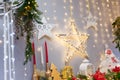 Merry Christmas, Happy New Year decorations with shiny stars, candles, white lantern, fir branches, bulbs, wooden toy hearts Royalty Free Stock Photo