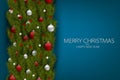 Merry Christmas and Happy New Year design concept. Fir tree branch decoration with glass balls and small stars on blue background. Royalty Free Stock Photo