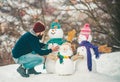 Merry Christmas and Happy new year. Enjoying nature wintertime. Snowman and funny bearded man in the snow. Happy smiling