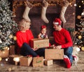 Merry Christmas and Happy New Year! Family gives present box to baby in living room decorated by christmas tree and xmas gift Royalty Free Stock Photo