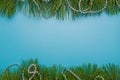 Merry Christmas, Happy New Year festive postcard, template, blue background, pine tree branches frame, silver beads. Copy space Royalty Free Stock Photo