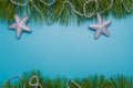 Merry Christmas, Happy New Year festive postcard, template, blue background, pine tree branches frame, silver beads, stars. Copy Royalty Free Stock Photo