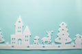 Merry Christmas and Happy New Year. Foam cutter of City with reindeers and snow boy, art and craft style on pastel color paper Royalty Free Stock Photo