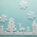 Merry Christmas and Happy New Year. Foam cutter of City with snow flake, art and craft style on pastel color paper