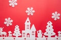 Merry Christmas and Happy New Year. Foam cutter of City with snow flake, art and craft style on red color paper Royalty Free Stock Photo