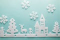 Merry Christmas and Happy New Year. Foam cutter of City with snowflake, art and craft style on pastel color paper