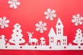 Merry Christmas and Happy New Year. Foam cutter of City with snow flake, art and craft style on red color paper Royalty Free Stock Photo