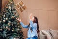 Merry Christmas and Happy New Year. Girl tossing present up. Happy child having fun Royalty Free Stock Photo