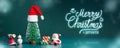 Merry Christmas and happy new year glowing snow falling with xmas tree and Santa clause, snowman and gift box on dark green Royalty Free Stock Photo