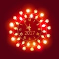Merry Christmas and Happy new year 2017 gold clock face with christmas glowing electric garland decorate on red background. Royalty Free Stock Photo