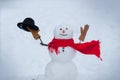 Merry Christmas and happy new year greeting card with copy-space. Snowman is standing in winter hat and scarf with red Royalty Free Stock Photo