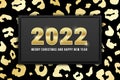 2022 Merry Christmas and Happy New Year greeting card design with shiny golden numbers and gold leopard pattern on black Royalty Free Stock Photo