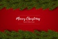 Merry Christmas and Happy New Year greeting card. Fir tree branch decoration on red background and typography text. Royalty Free Stock Photo