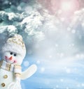 Merry christmas and happy new year greeting card. Happy snowman standing in winter christmas landscape.Snow background. Royalty Free Stock Photo