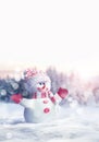 Merry christmas and happy new year greeting card. Happy snowman standing in winter christmas landscape.Snow background. Royalty Free Stock Photo