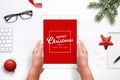 Merry Christmas and Happy New Year greeting card on tablet with red background. Top view composition with Christmas, New Year deco Royalty Free Stock Photo