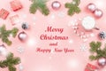 Merry Christmas and Happy New Year greeting card. Christmas tree and decorations on pink, top view Royalty Free Stock Photo