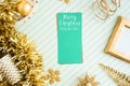 Merry christmas and happy new year greeting card view of sparkling gold tinsel,ball,ornament decorate on green strip line table. Royalty Free Stock Photo