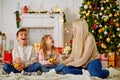 Happy family is waiting for the New Year. mom and children decorate the Christmas tree