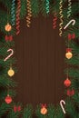 Merry Christmas and Happy New Year. Holiday background. Christmas wreath made of pine wood, decorated with glass balls and candies