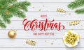 Merry Christmas and Happy New Year holiday golden decoration and calligraphy font for greeting card on white wooden background. Ve Royalty Free Stock Photo