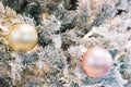 Merry Christmas and Happy New Year holiday postcard. Golden baubles on spruce tree.Balls and garlands hanging on pine Royalty Free Stock Photo