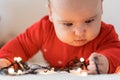 Merry christmas and happy new year, infants, childhood, holidays concept - close-up 6 month old newborn baby in red clothes on his Royalty Free Stock Photo