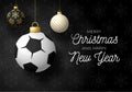 Merry Christmas and Happy New Year luxury Sports greeting card. Soccer Football ball as a Christmas ball on black background. Royalty Free Stock Photo