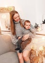 Merry Christmas and Happy New Year! Mom and son smiling in holiday living room, decorated for holiday. Portrait loving family