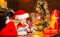 Merry Christmas and Happy New year. Mother and son writing letter to Santa. Gifting culture. Royalty Free Stock Photo