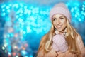 Merry Christmas and Happy New Year! Portrait of happy cheerful beautiful woman in knitted hat and mittens staying outdoor Royalty Free Stock Photo