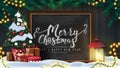 Merry Christmas and happy New Year, postcard with wooden wall, Christmas tree branches, garland, chalk board with lettering.