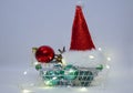 Merry Christmas and Happy New year:Santa Claus hat Christmas balls and electric garland in shopping basket Royalty Free Stock Photo