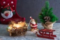 Merry christmas and a happy new year. a Santa Claus toy, a burning candle and a sleigh. Christmas Holidays. set of Christmas ornam Royalty Free Stock Photo