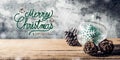 Merry Christmas and happy new year sign with Christmas tree  bauble and pine cone on wood table with concrete wall for celebrate Royalty Free Stock Photo